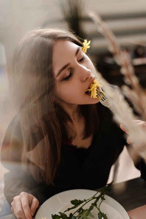 Free Woman Eating Flowers Stock Photo