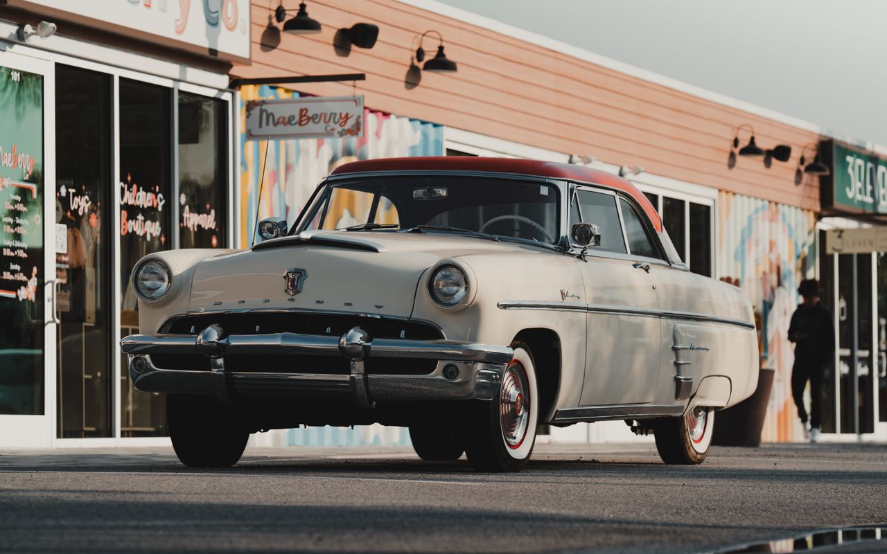 Vintage Mercury Monterey car parked outside shops on a sunny day in Wesley Chapel, FL.