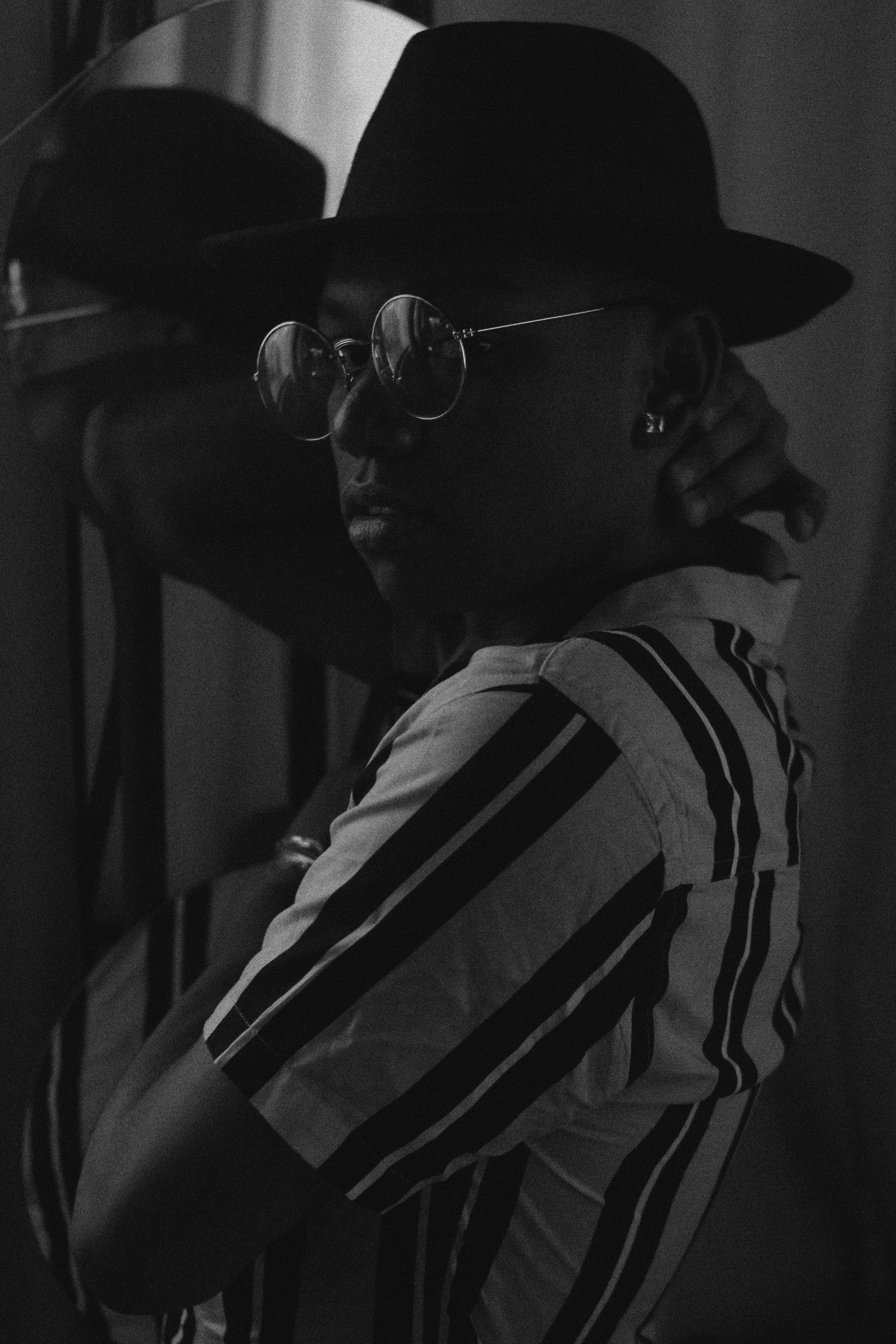 Chic black and white portrait of a man wearing a fedora, captured in São Paulo.