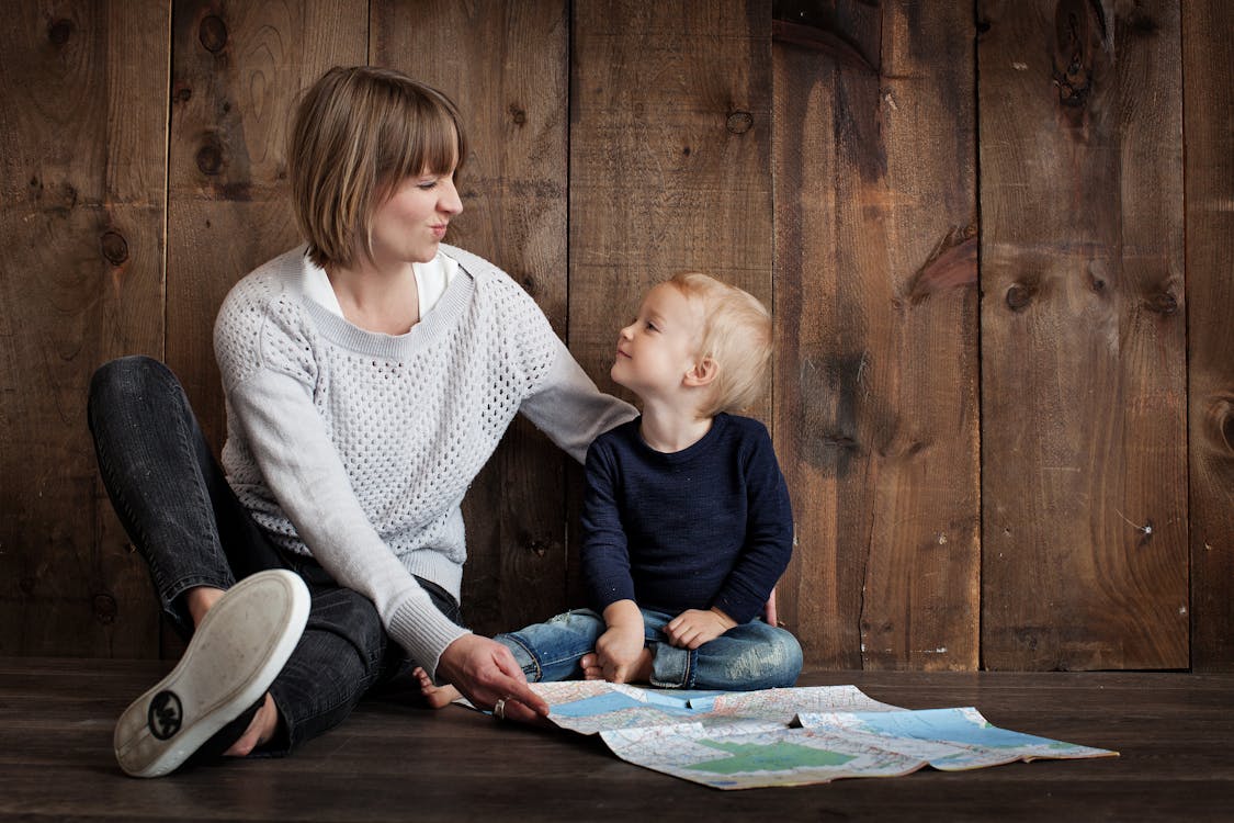 Free Child With Woman Holding Map Stock Photo