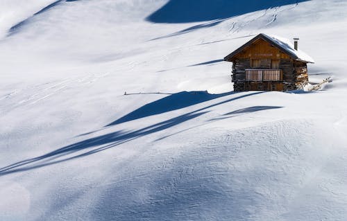 Коричневый деревянный дом на снегу