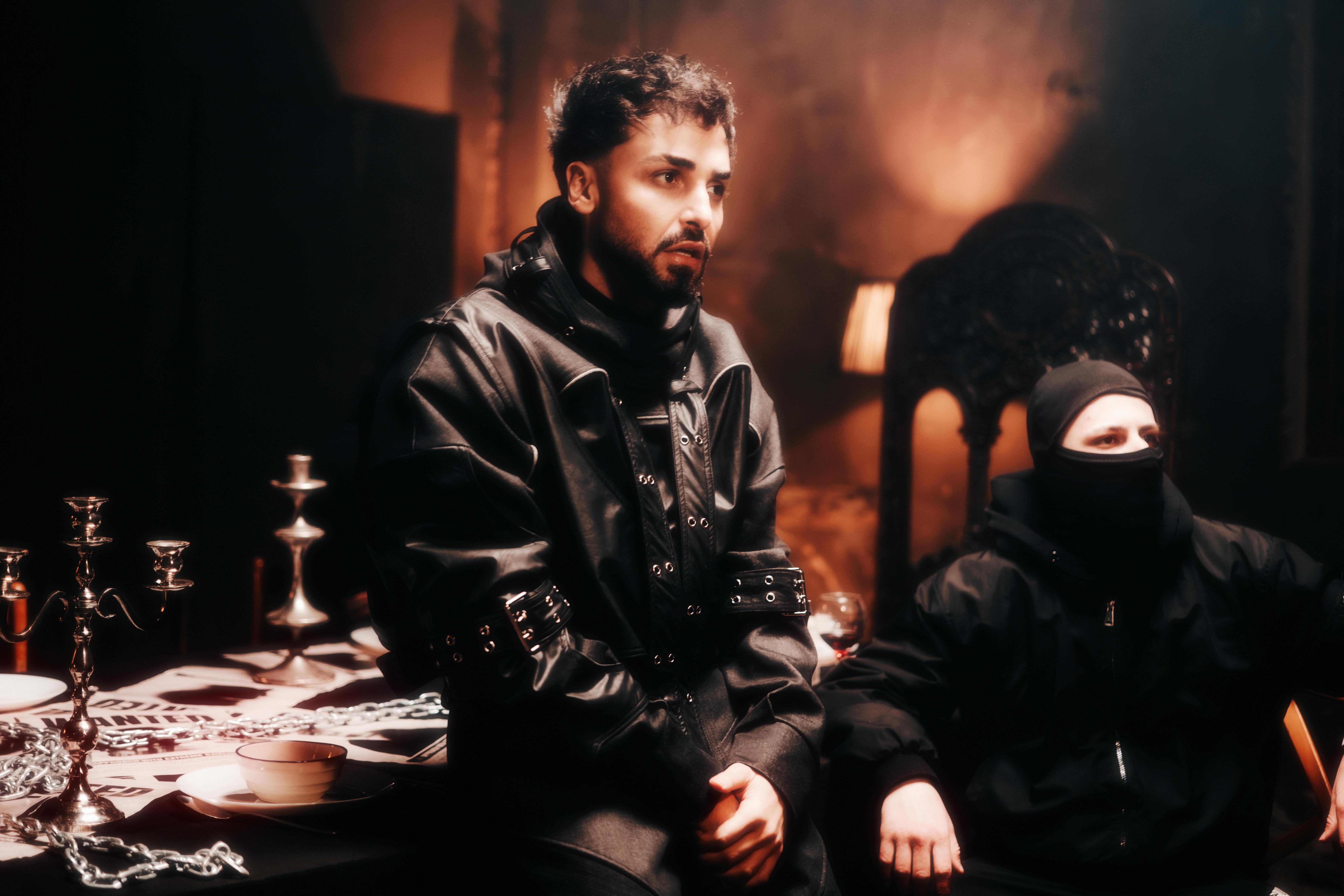 Stylish men in leather and balaclavas, capturing a moody, contemporary fashion scene.