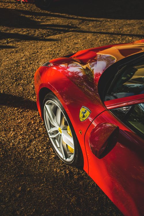 Free A stunning close-up of a sleek red luxury sports car captured during sunset, highlighting its design. Stock Photo