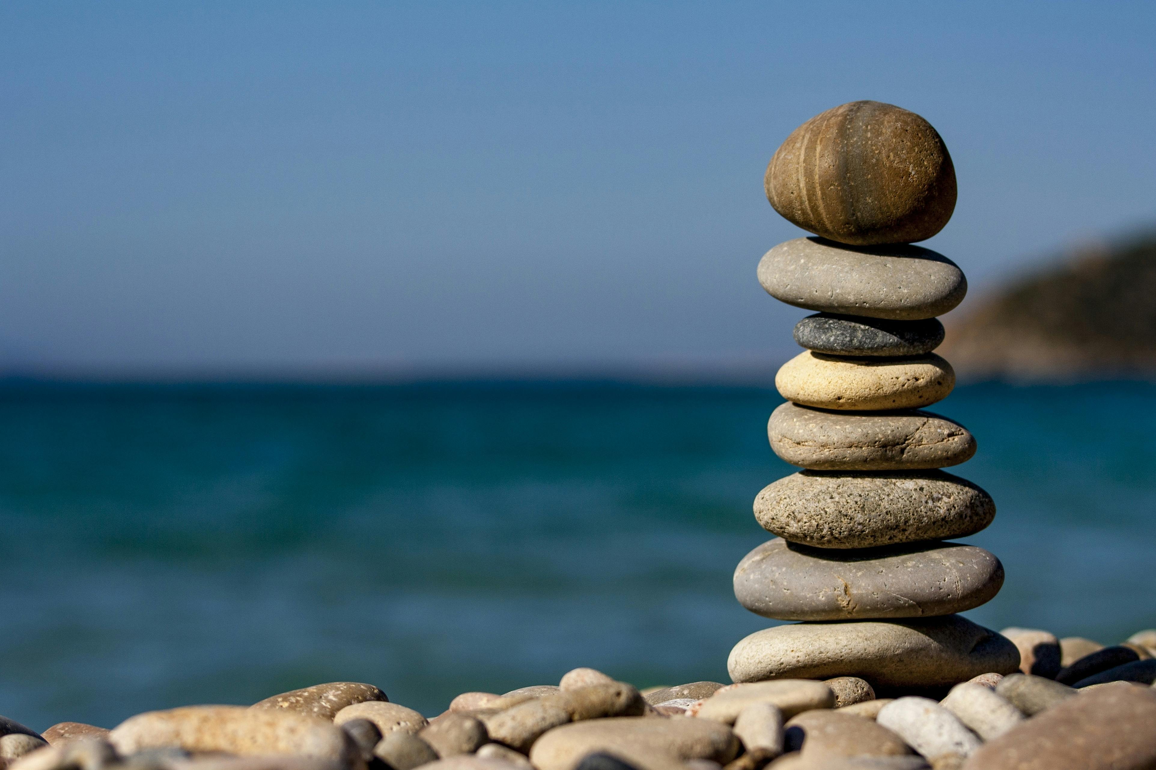 Free Cairn Stones and Body of Water in Distance Stock Photo