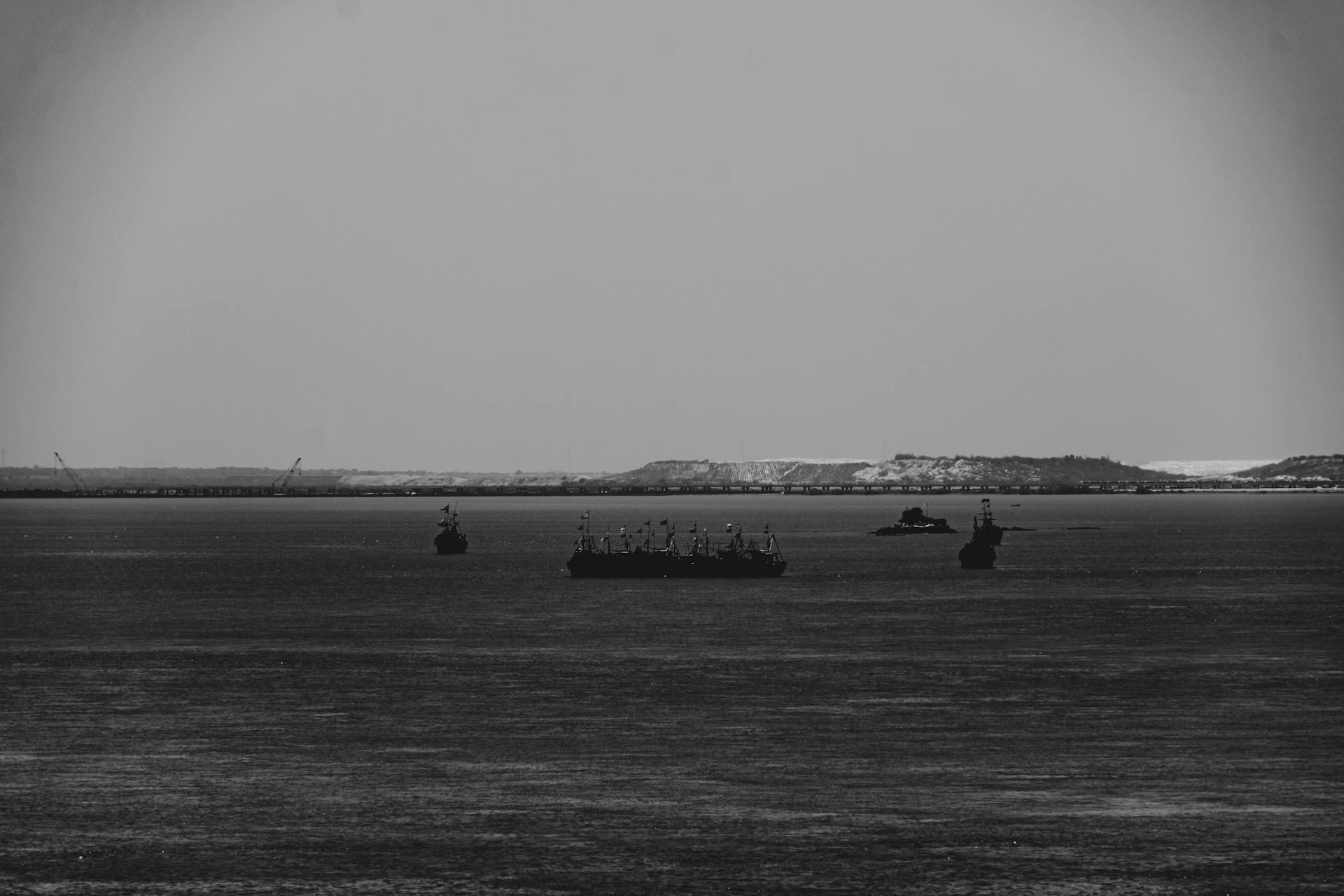 Black and white image of ships on the sea near Dwarka, India.