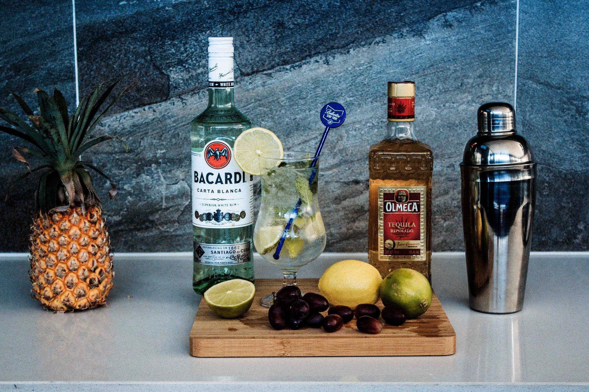 Tropical cocktail with fruit garnish representing a rum-based drink made with falernum