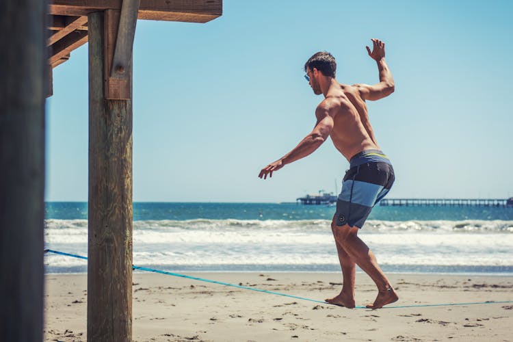 Man Balancing On Rope