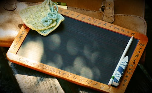 Brown and Black Writing Board With Pen