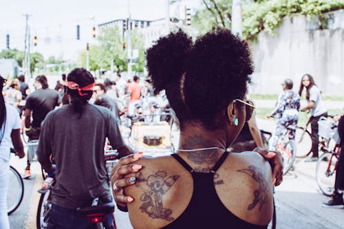Tattooed Woman Wearing Black Tank Top