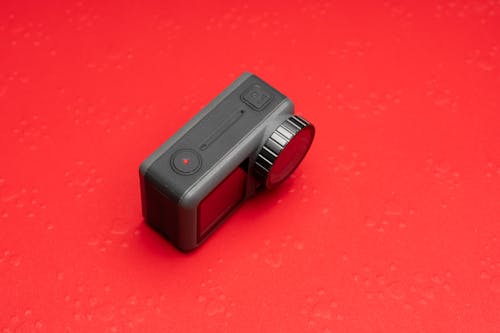 A camera on a red background with a red background