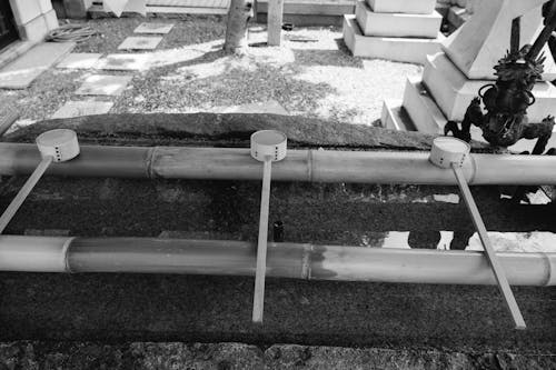 A black and white photo of a tomb with a metal pole