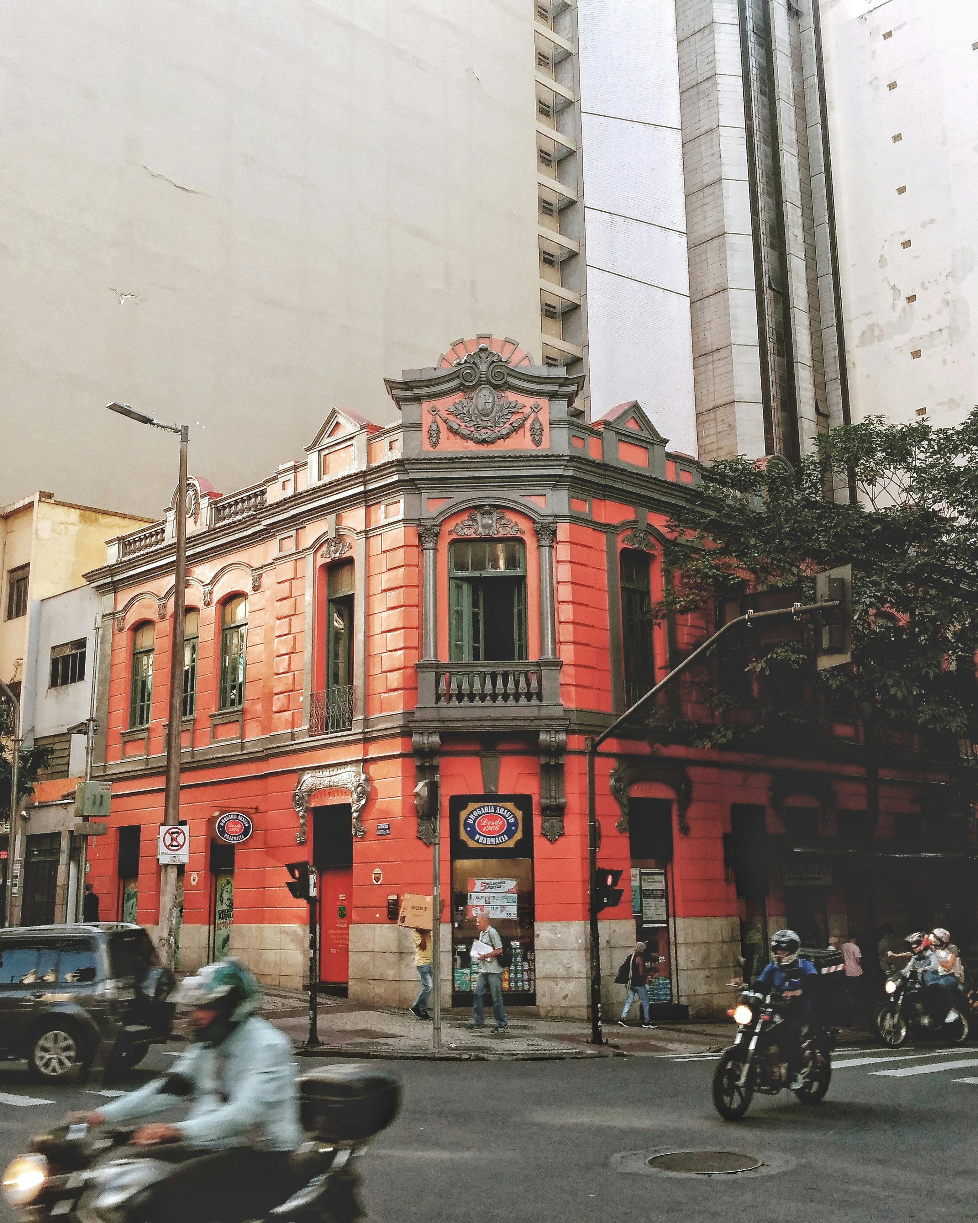 Street view of a vibrant red historic building in downtown Belo Horizonte, Brazil.