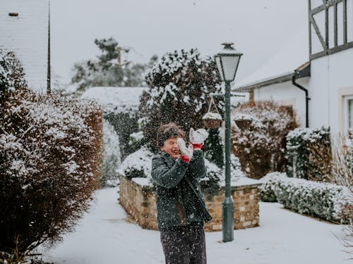 Free Boy Playing Outside While Snowing Stock Photo