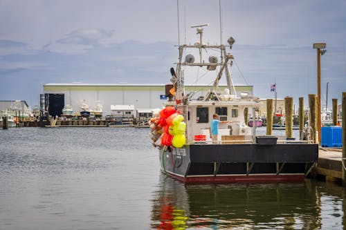 A fishing boat is docked at a dock