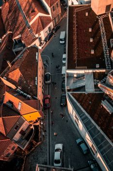 A stunning aerial view of Porto's urban landscape with red rooftops and cobblestone streets during sunset.