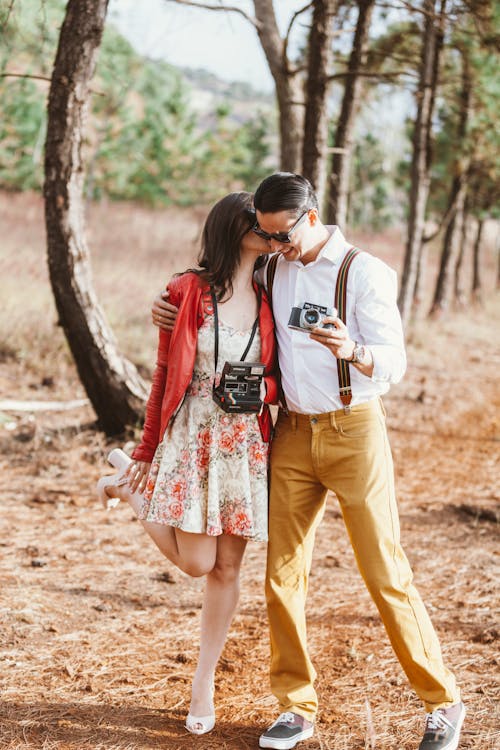 Free Man and Woman Holding Cameras Stock Photo