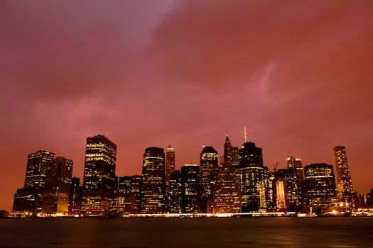 Beautiful view of the New York City skyline with city lights illuminating the dusk sky.