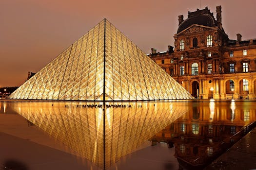 Stunning nighttime view of the illuminated Louvre Pyramid and reflection in Paris, France. by Pixabay