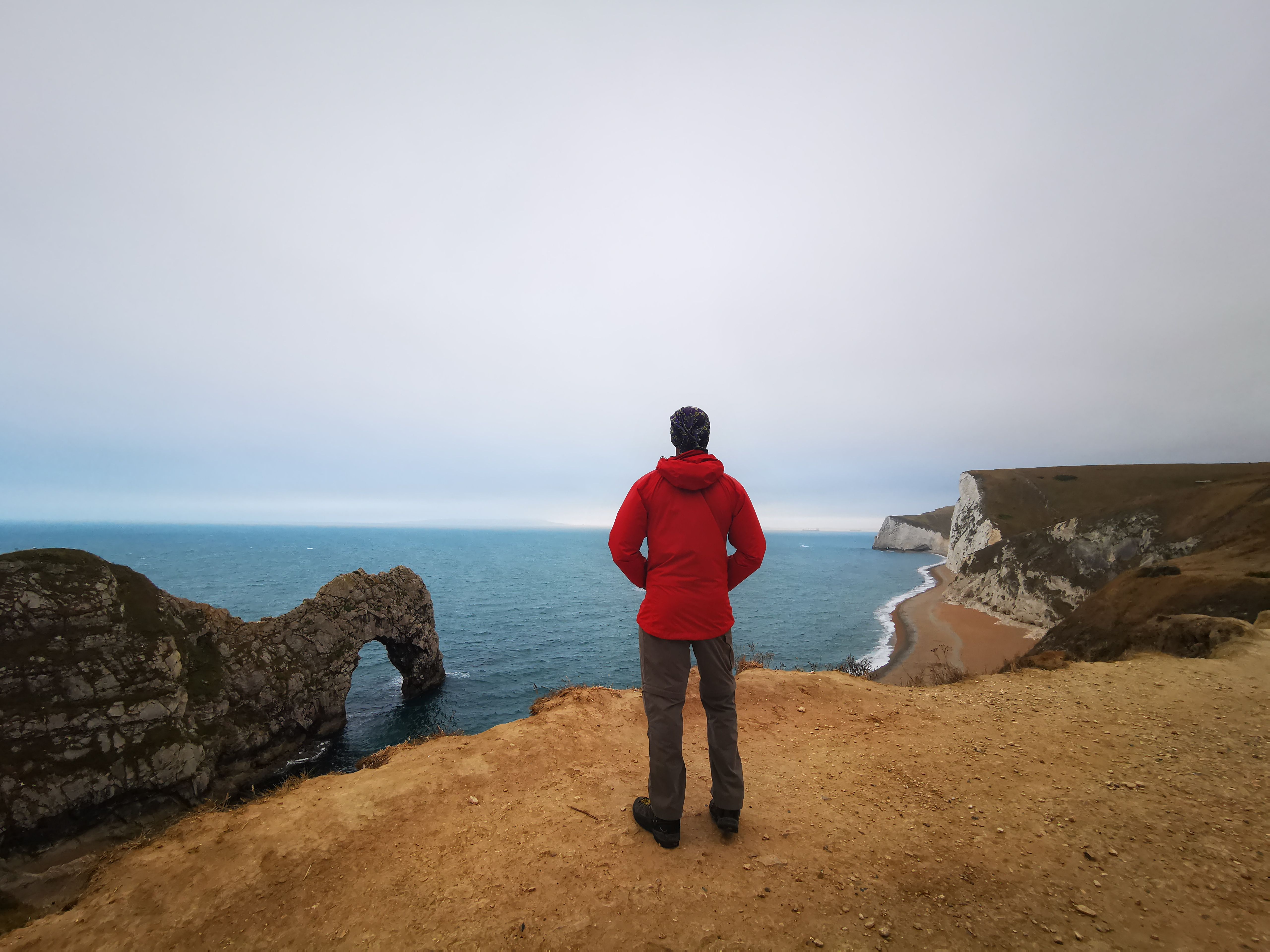 DI Matthew Venn looking pensively over a misty English coastline from "The Long Call"