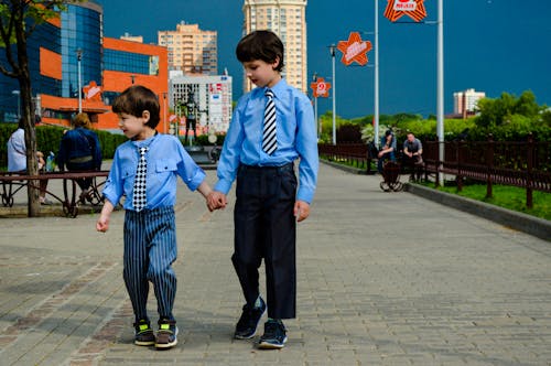 Two Boys Walking On Park