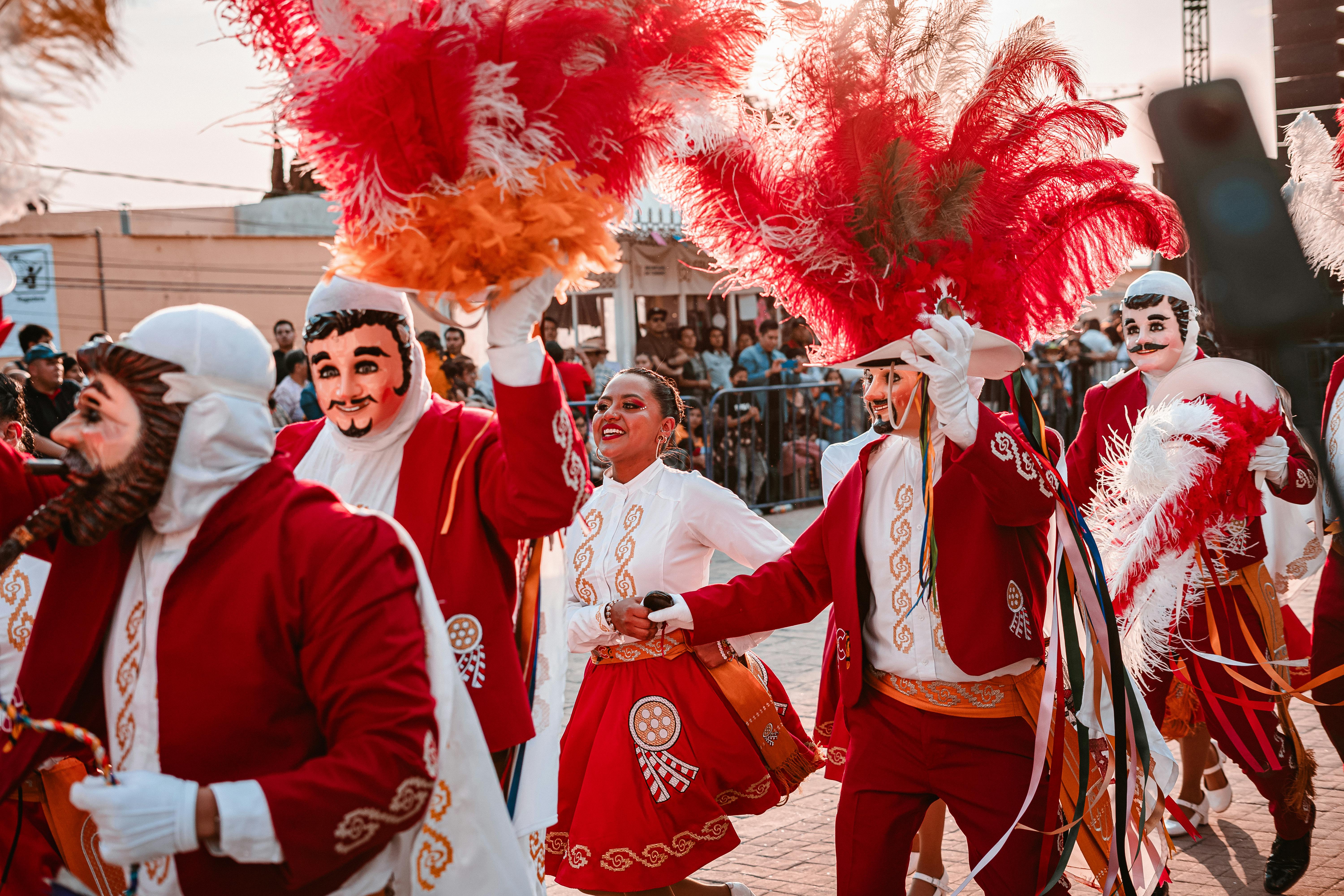 Colorful parade with feathered costumes and masks in Tlaxcala, Mexico, showcasing vibrant traditions.