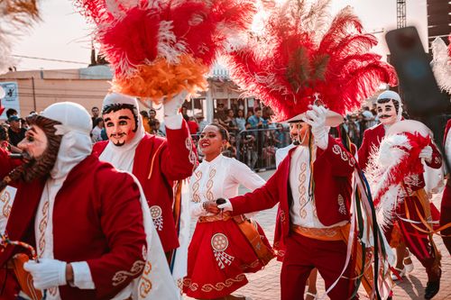 Free Colorful parade with feathered costumes and masks in Tlaxcala, Mexico, showcasing vibrant traditions. Stock Photo