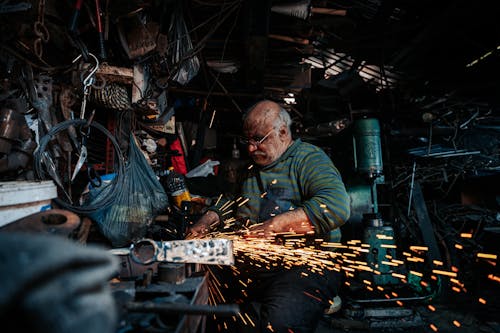Man Sitting and Working at Workshop