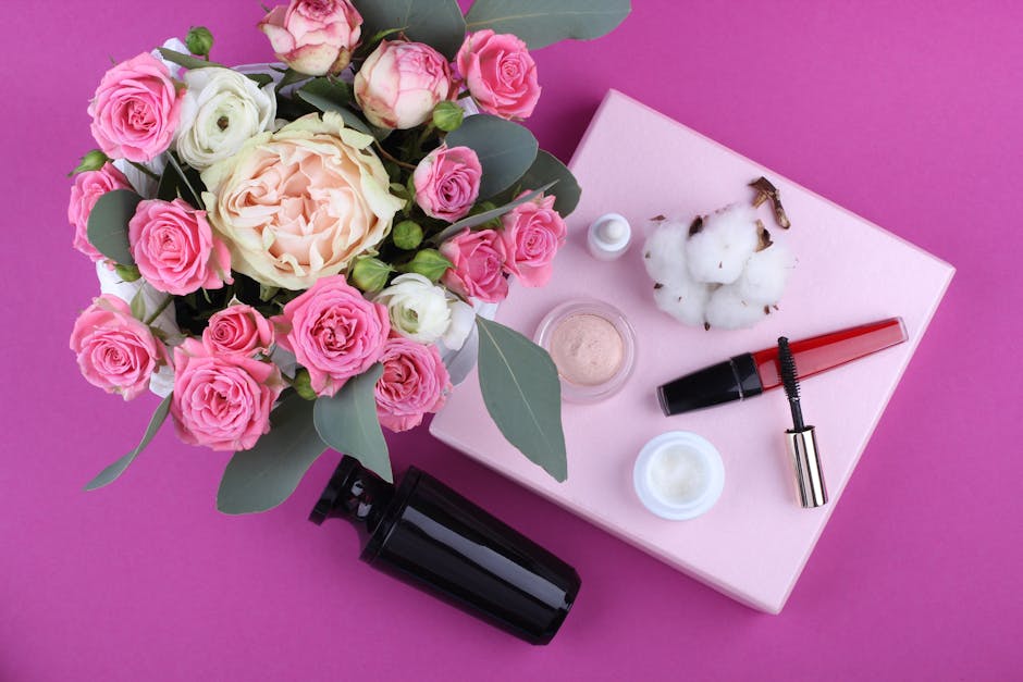 Top View Photography of Pink and White Rose Flowers in Vase Beside Assorted Cosmetics on Pink Surface