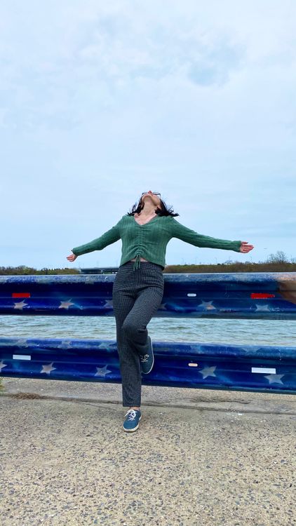 Leaning Back Against Railing Woman Leaning Back against Painted Railing next to River · Free Stock Photo