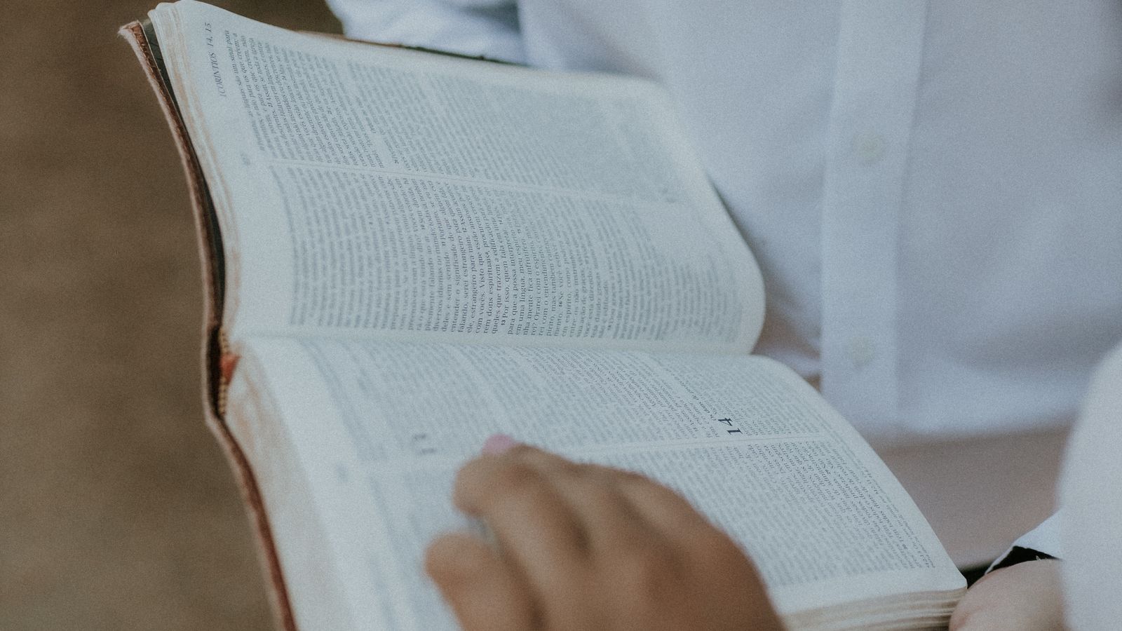 An open Bible being held
