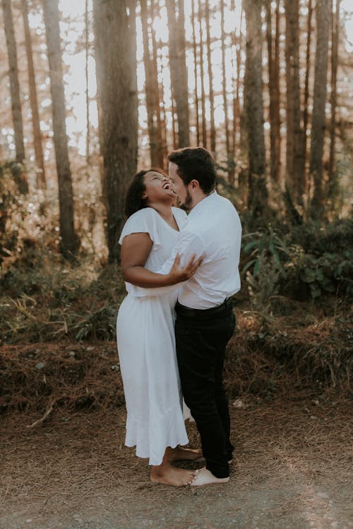 A couple embracing in the woods during their engagement session