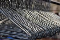 Empty metal hangers on rod