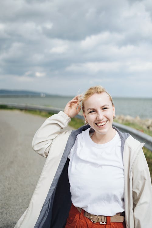 A woman standing on a road with her hair up