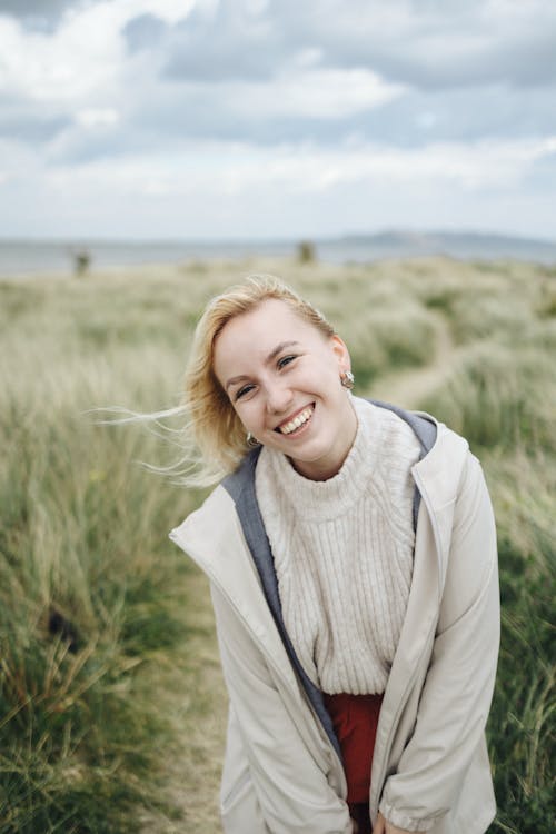 A woman smiling in a field of grass