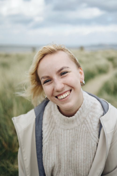 A woman smiling in a field