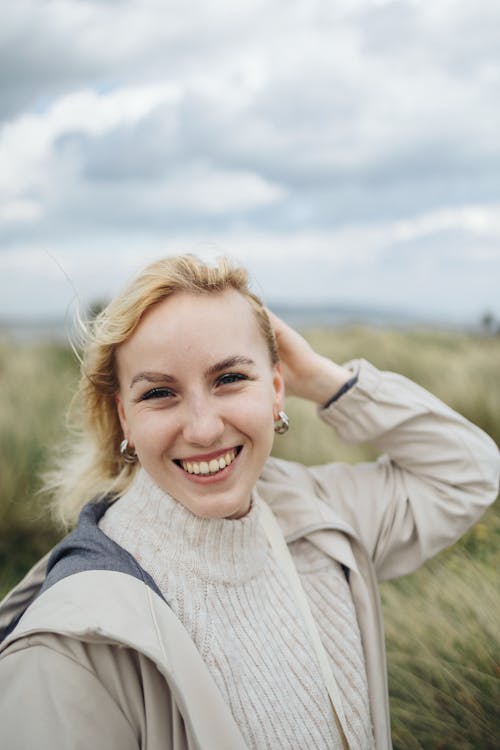 A woman smiling in a field