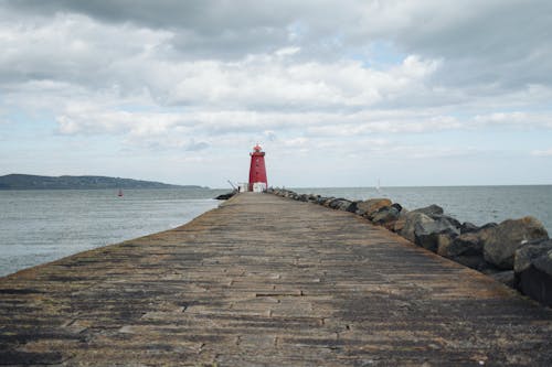 A red lighthouse on a pier
