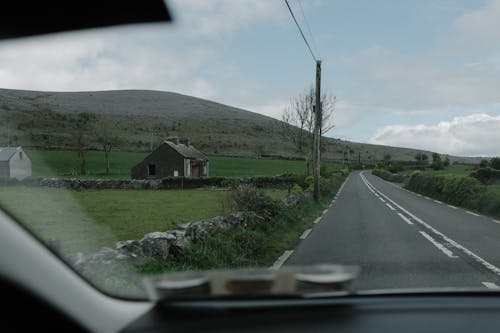 A view from the car window of a rural road