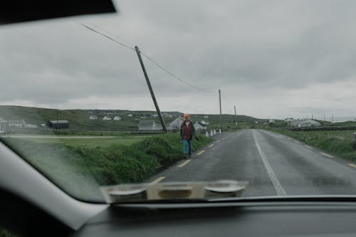 A person walking down the road on a rainy day