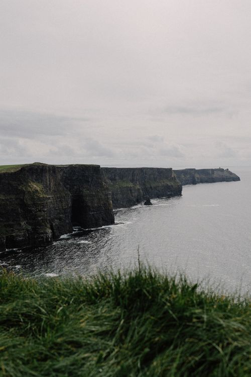Free Dramatic view of the Cliffs of Moher against the Atlantic Ocean in Ireland. Stock Photo