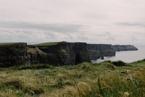 A view of cliffs and grass on a cloudy day
