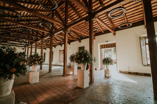 A large room with wooden beams and flowers
