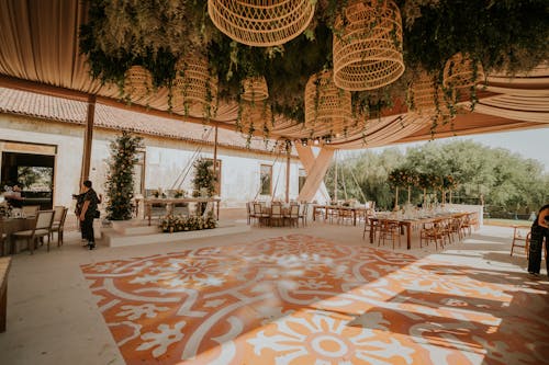 A wedding reception with a large orange and white floor