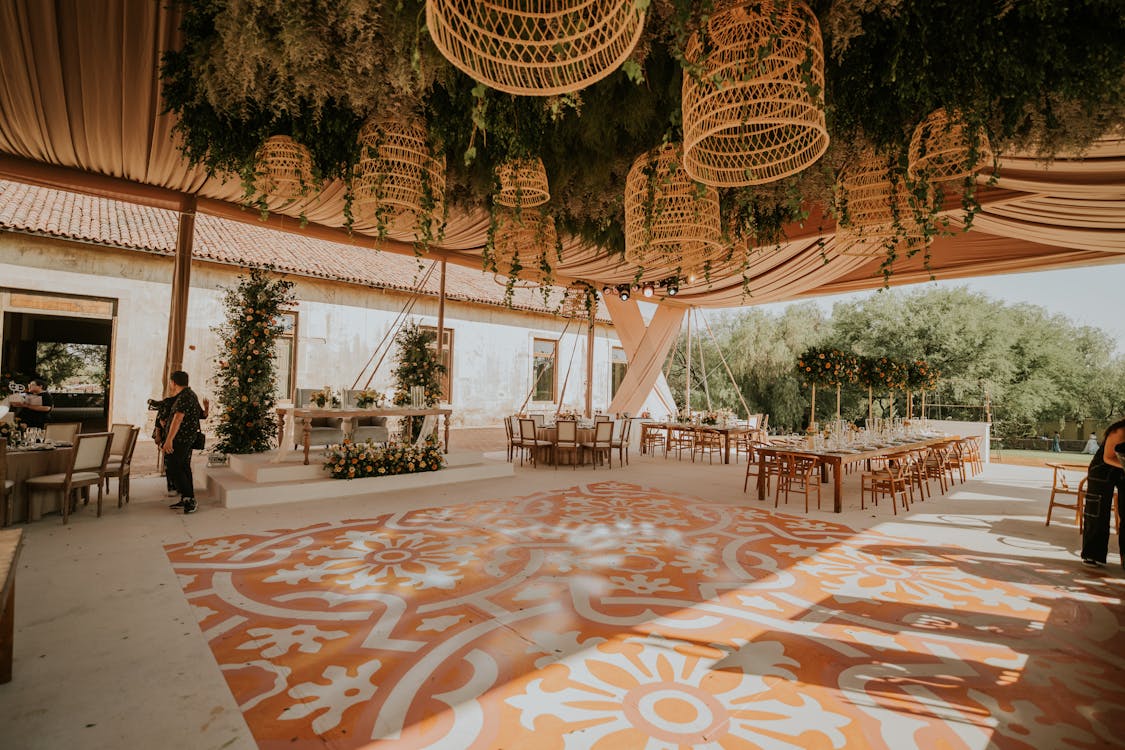 A wedding reception with a large orange and white floor