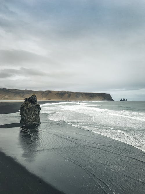 Free Photo of Seashore Under Cloudy Sky Stock Photo