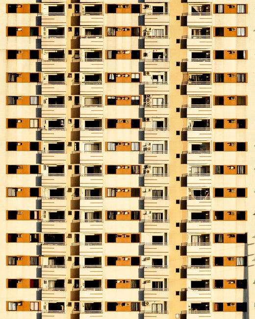 Close-up view of a high-rise apartment building facade in Belém, displaying symmetrical balconies.