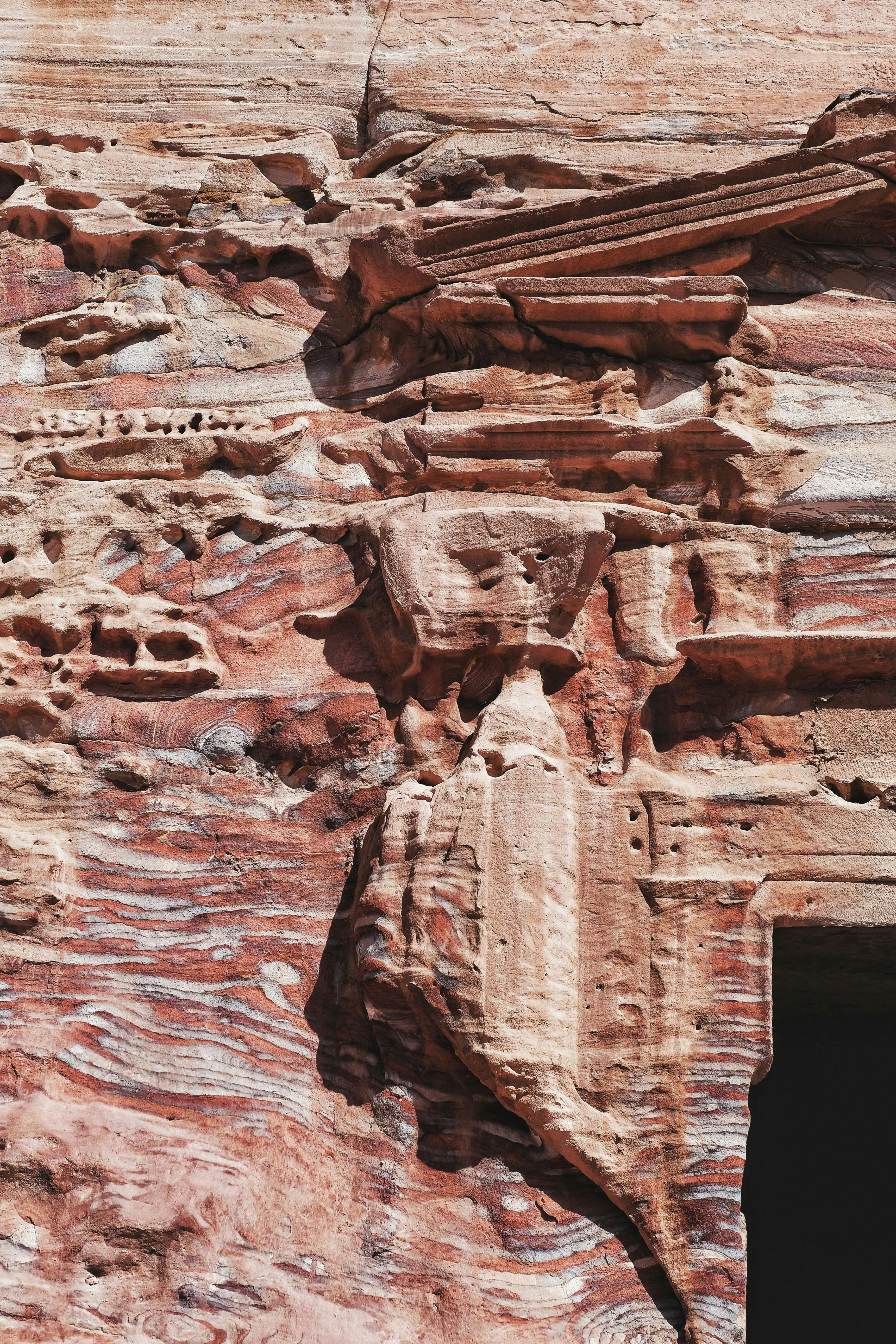 Intricate sandstone carvings showcasing the ancient Nabataean artistry in Petra, Jordan.