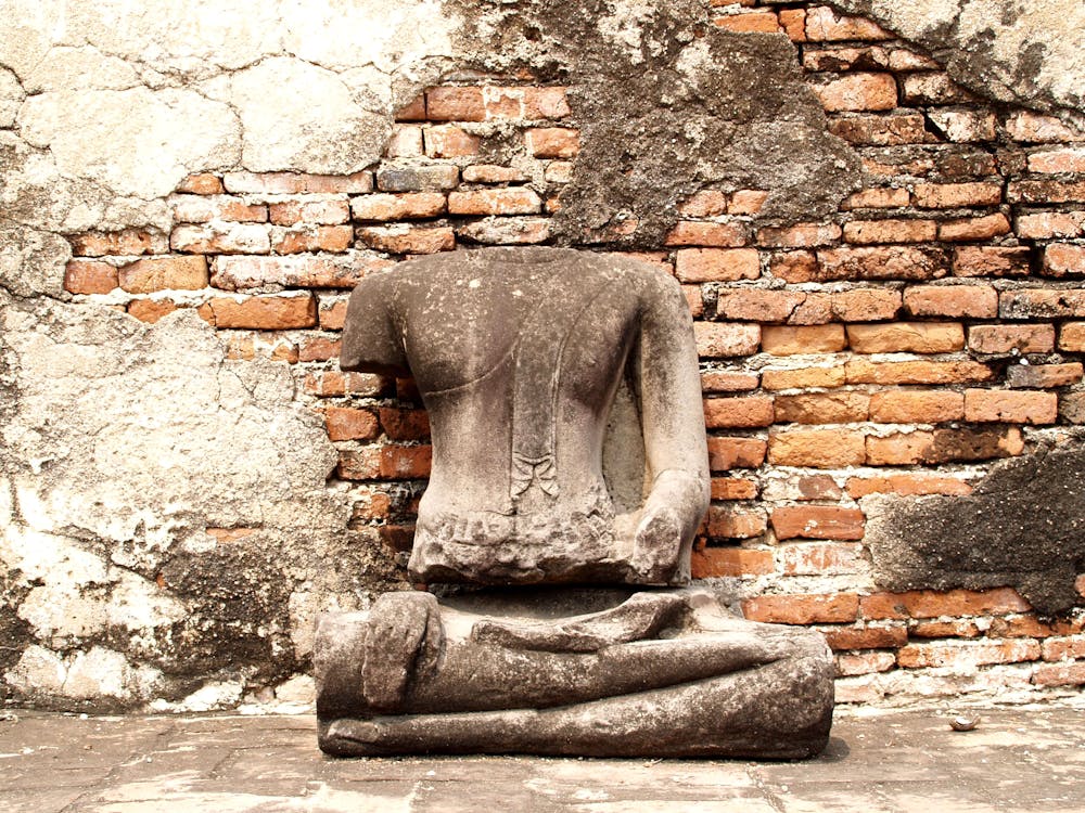 Headless Statue Sited in Front of Wall