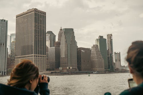 Two people looking at the city skyline from a boat