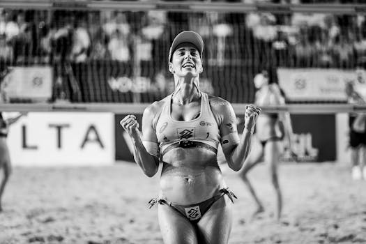 Joyful athlete celebrating a win at a beach volleyball game in João Pessoa, Brazil.